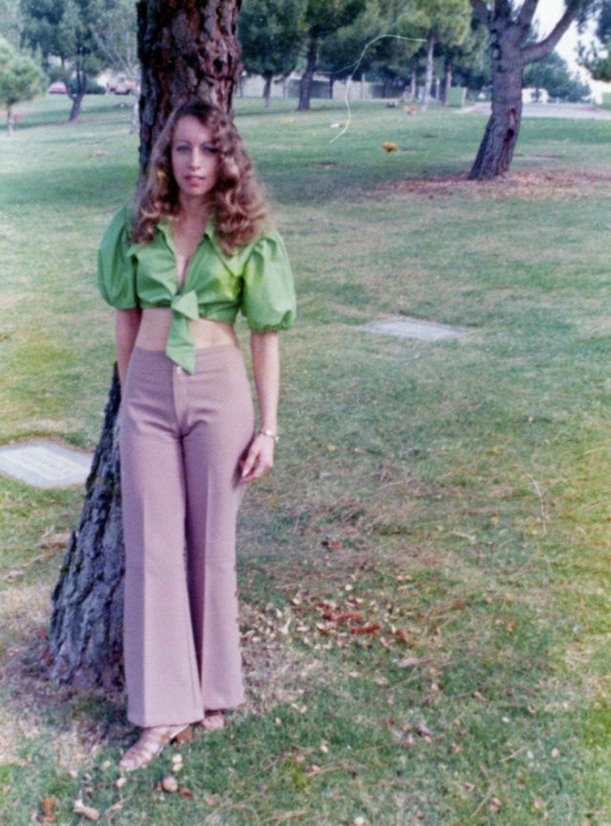 Unknown lady posing against a tree in the mid 1970s. 